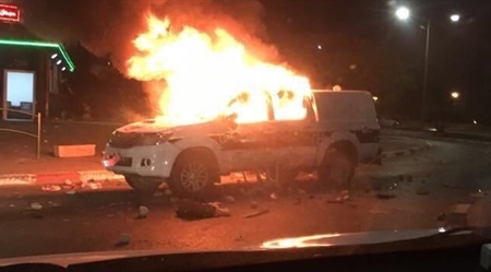 Burning police vehicle in Kafr Qasem